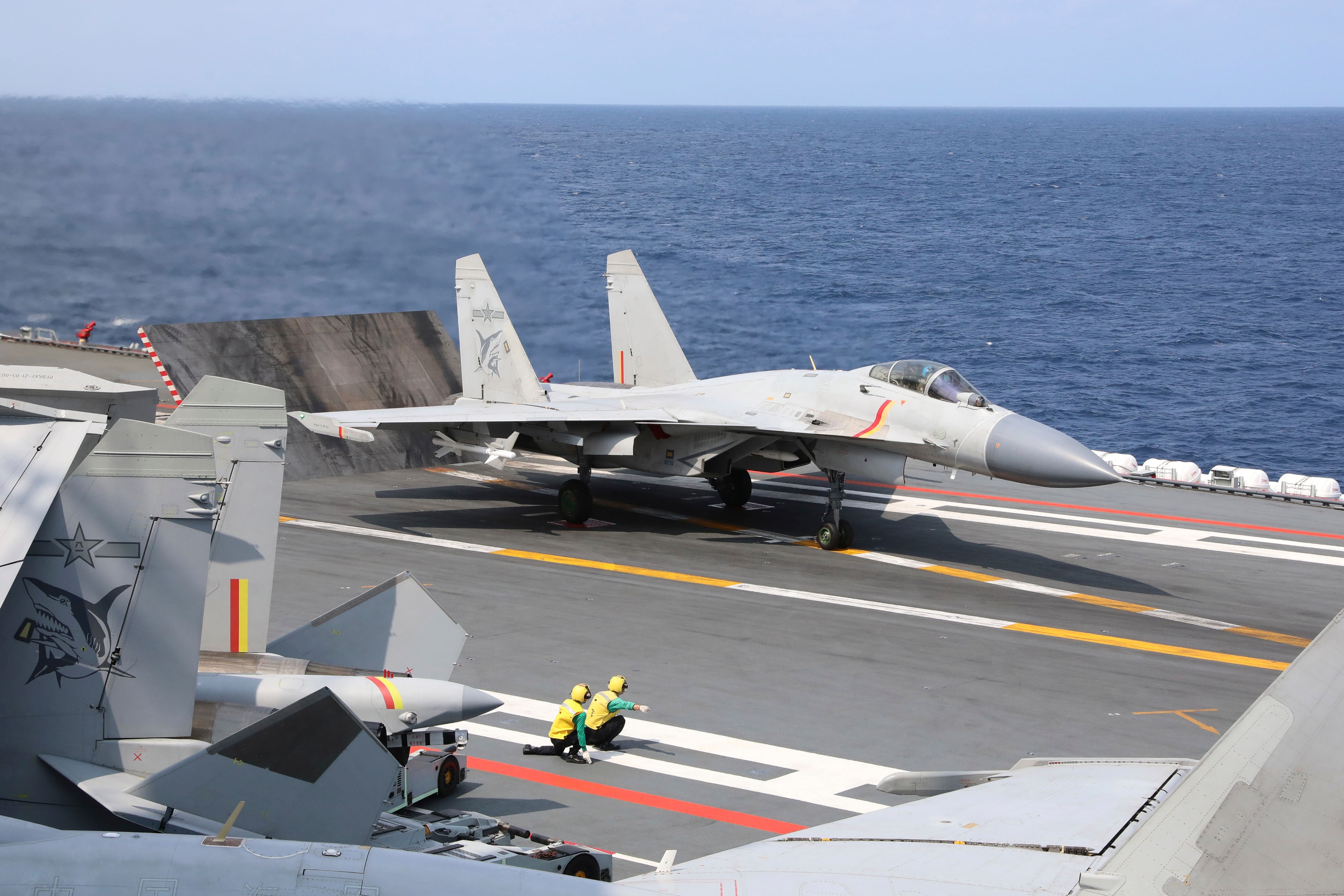 A Chinese J-15 fighter jet takes off from an aircraft carrier.