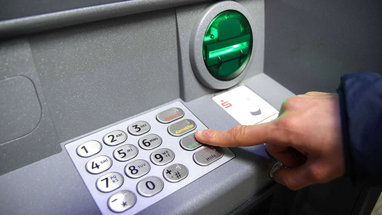 Winches theme picture - bank machine, cash dispenser, cash dispenser theme picture bank machine, cash dispenser, cash dispenser Withdraw money at a bank machine, pull money at a cash dispenser of a Volksbank, savings bank theme picture, feature picture, Copyright: xFleigx xEibner Press