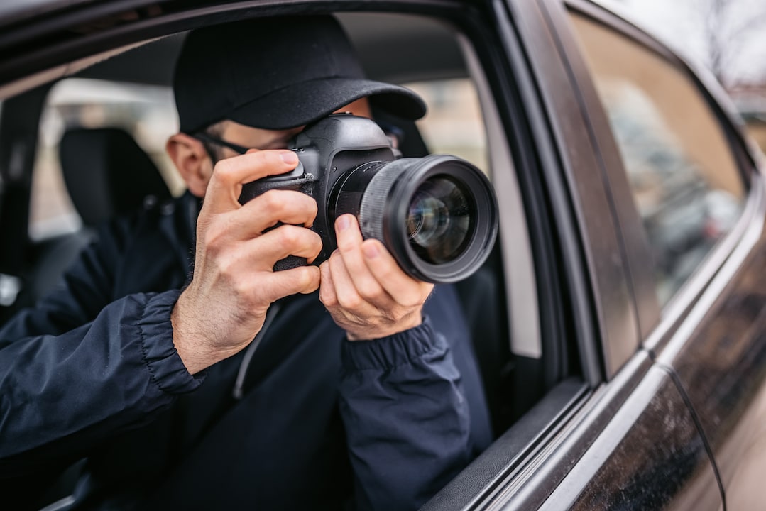 Private detective takes photos from the car