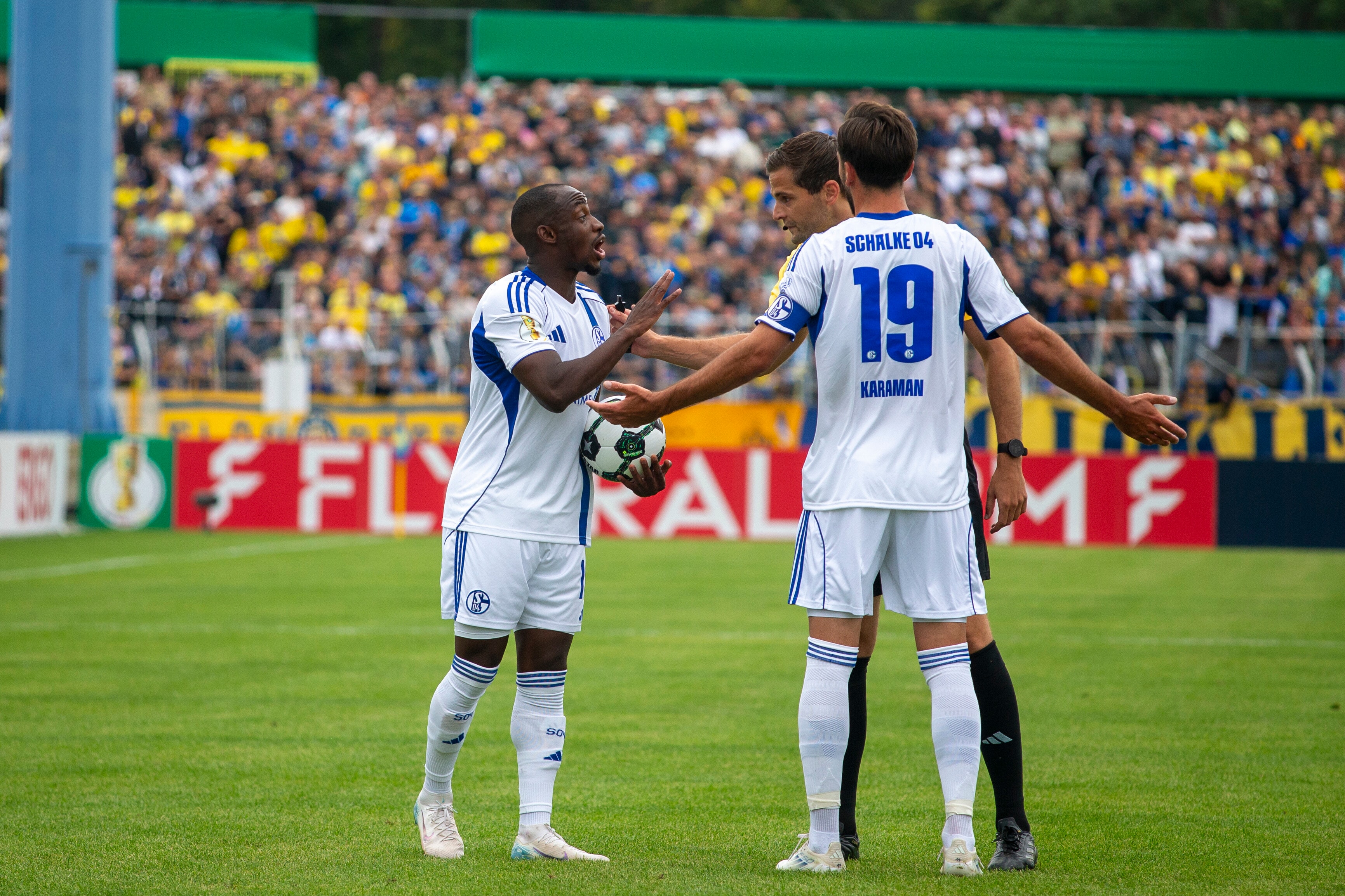 Antwi-Adjei (l) de Schalke discute con el árbitro