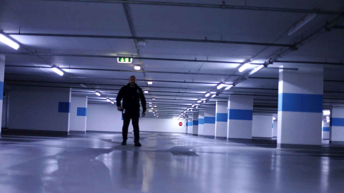 Eine Person steht auf einem Parkhausdeck.
